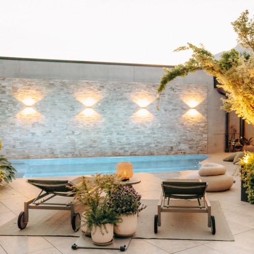 Terrassen Design mit Pool, zwei Liegestühle und Lichtkonzept